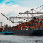 Shipping containers stacked at a U.S. seaport, similar to those CBP officers screen for stolen vehicle exports