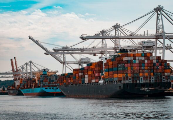 Shipping containers stacked at a U.S. seaport, similar to those CBP officers screen for stolen vehicle exports