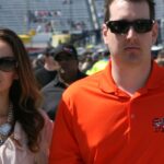 Samantha Busch and Kyle Busch walking through a NASCAR pit area