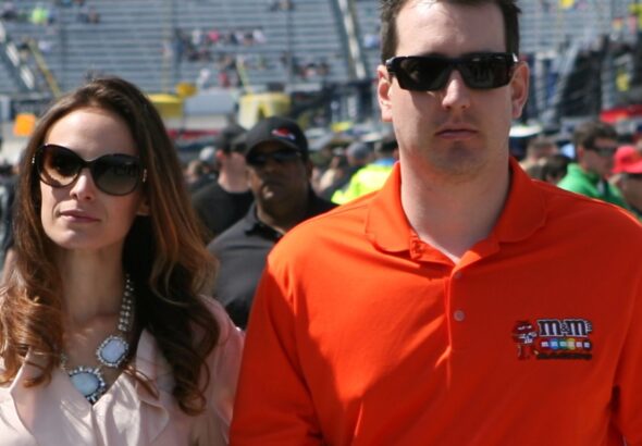 Samantha Busch and Kyle Busch walking through a NASCAR pit area