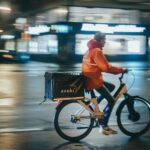 a man riding a bike down a street at night
