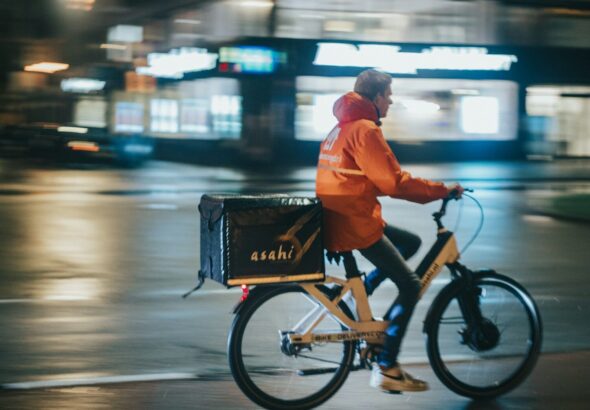 a man riding a bike down a street at night
