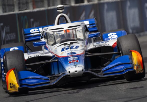 Blue and white race car speeding on track