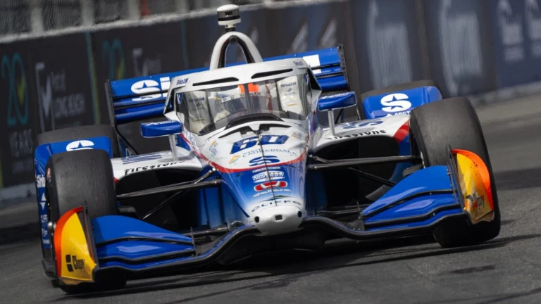 Blue and white race car speeding on track