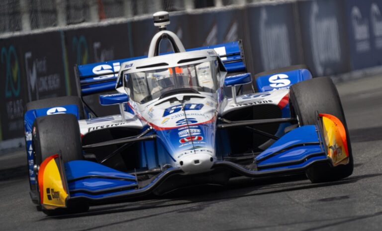 Blue and white race car speeding on track