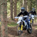 Husqvarna FE enduro motorcycles riding off-road, the model line affected by the rear brake caliper recall