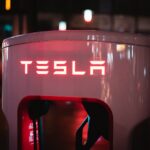 a red tesla logo on a white machine
