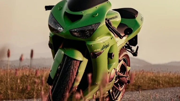 A bright green sport motorcycle parked on a road.