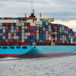 blue and red cargo ship on sea during daytime
