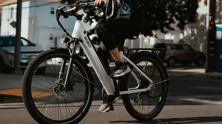 man in black jacket riding on white and black bicycle