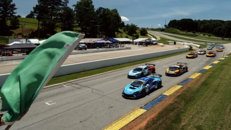 Green flag waves as McLaren Artura Trophy cars take the green at a McLaren Trophy America race, the IMSA-sanctioned one-make series.