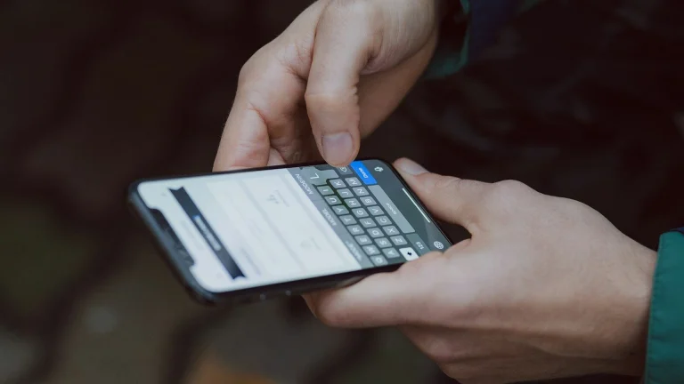 selective focus photography of person using smartphone
