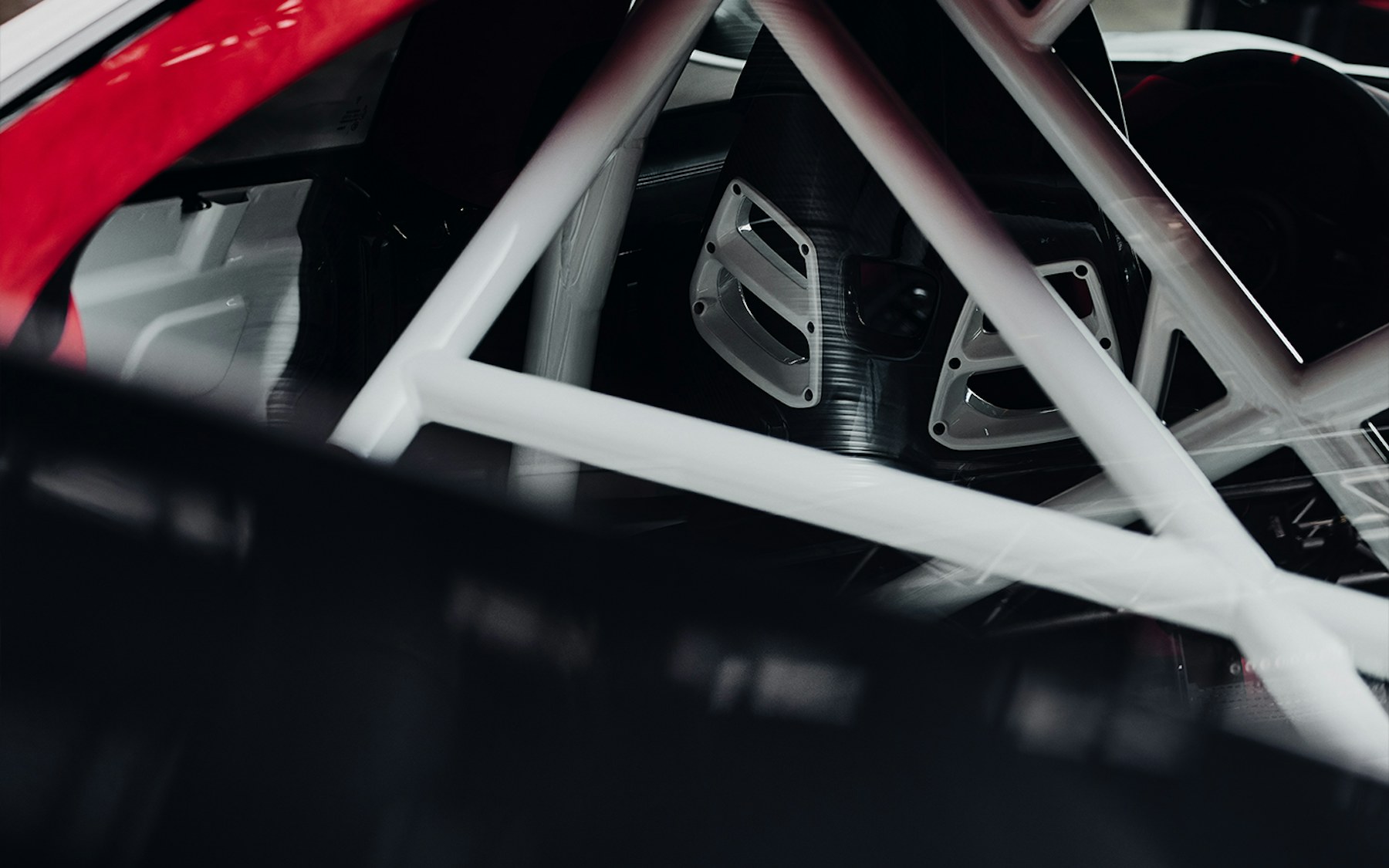 Interior of the Porsche 911 Flachbau RS showing carbon bucket seats and the stripped-out area behind the seats