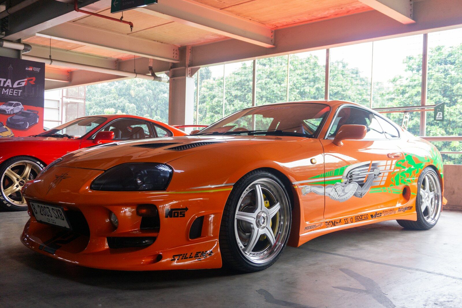 Iconic orange customized sports car on display.