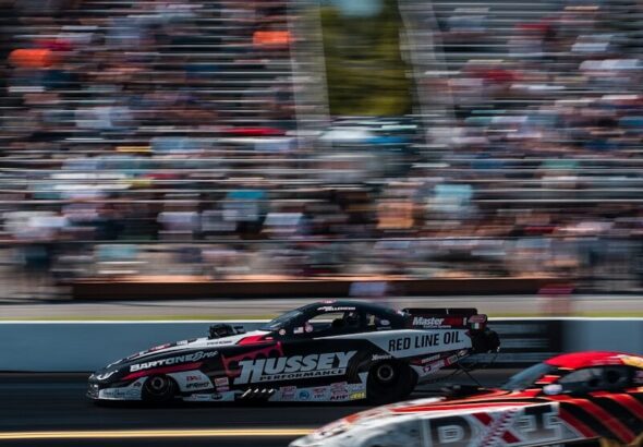 Nitro drag racing funny car launching off the line at a dragstrip