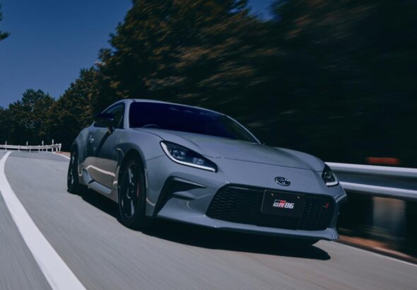 Updated 2026 Toyota GR86 in Solid Gray paint driving on a mountain road