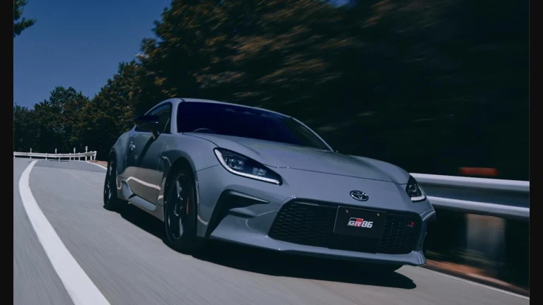 Updated 2026 Toyota GR86 in Solid Gray paint driving on a mountain road