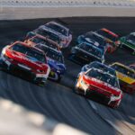 Race cars speeding around a track during a race