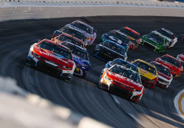 Race cars speeding around a track during a race