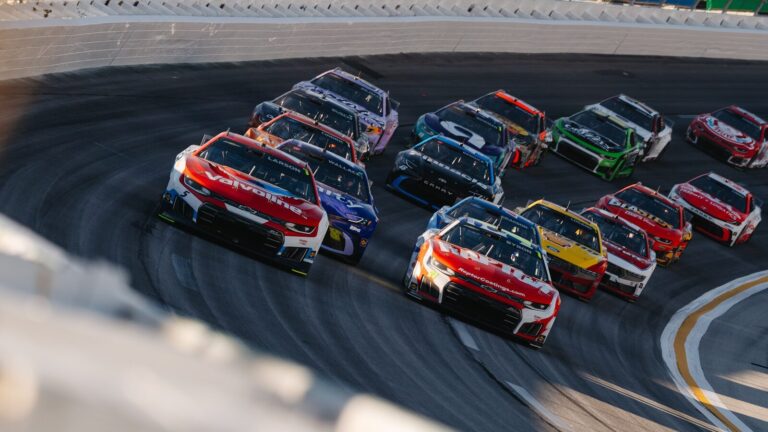 Race cars speeding around a track during a race
