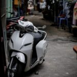 a white and black motorcycle parked next to a building