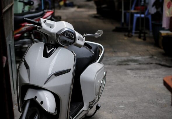 a white and black motorcycle parked next to a building