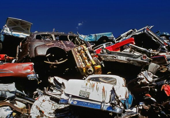 a pile of old cars sitting next to each other