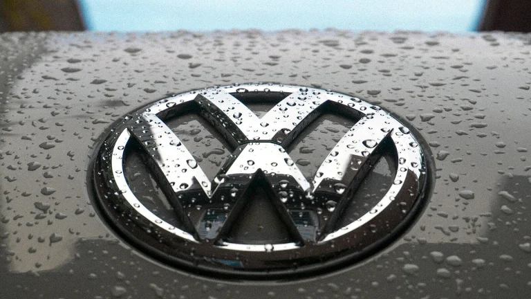 water dew on silver Volkswagen car emblem