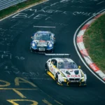 Two running cars on race track