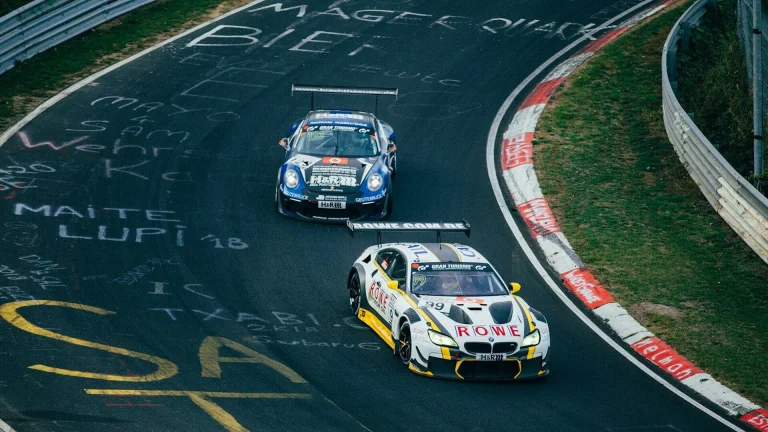 Two running cars on race track