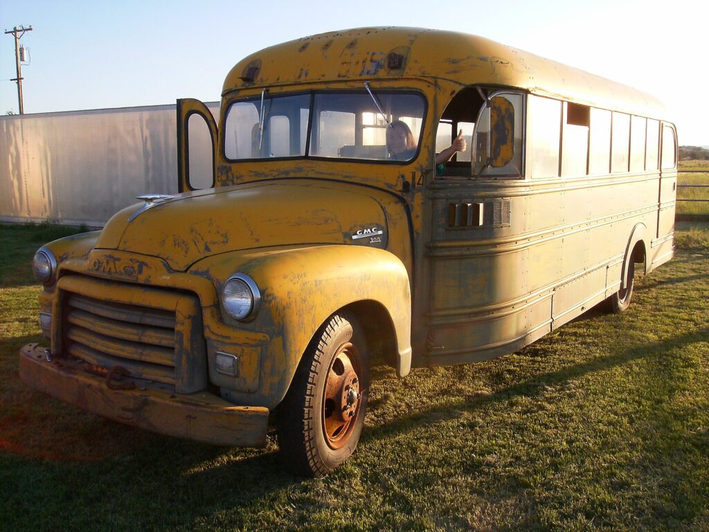 Yellow 1950s GMC school bus with Carpenter body, the type of conventional bus the Partridge Family bus started as
