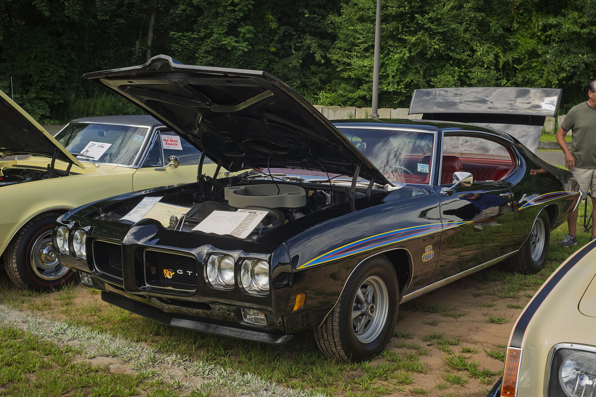 Black 1970 Pontiac GTO Judge Ram Air IV coupe with hood open at a car show