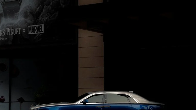 a blue car parked in front of a building