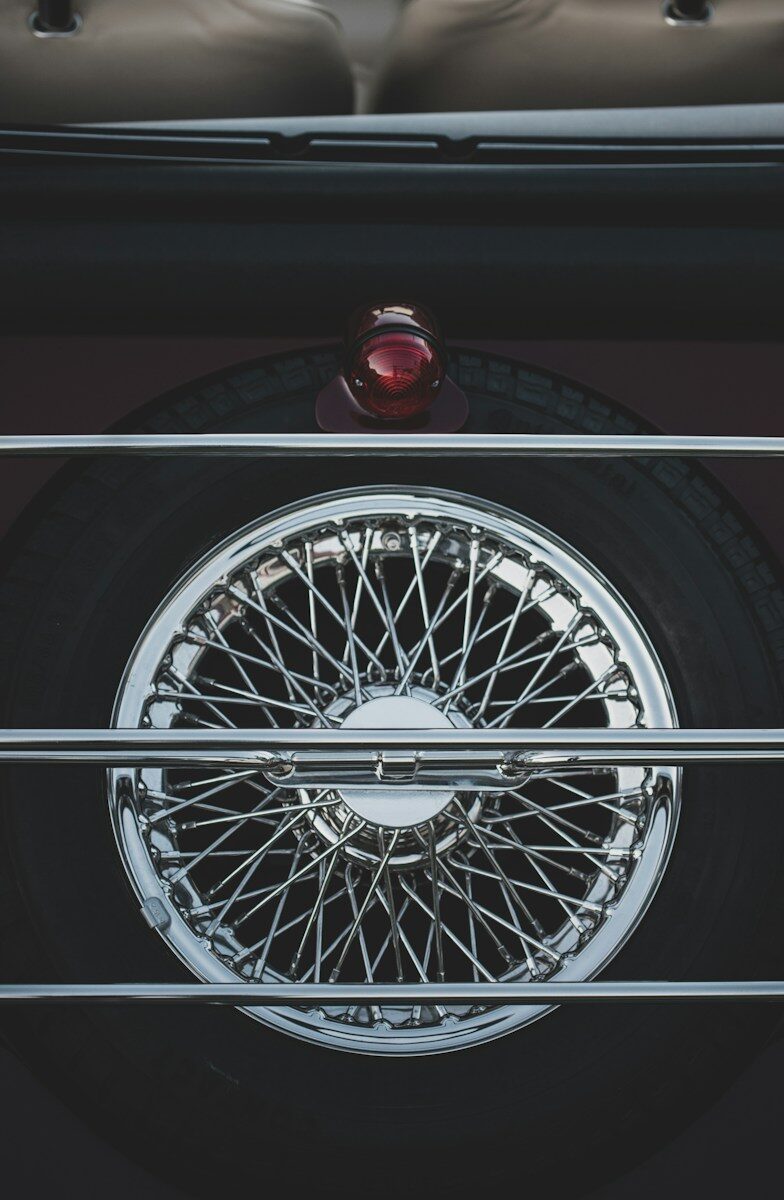 Close-up of an open wire-spoked wheel showing exposed spokes and a protruding center hub
