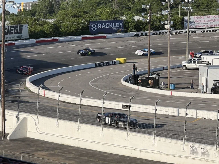 A Pro Late Model race car navigates a turn during weekly short-track racing action at Nashville Fairgrounds Speedway.