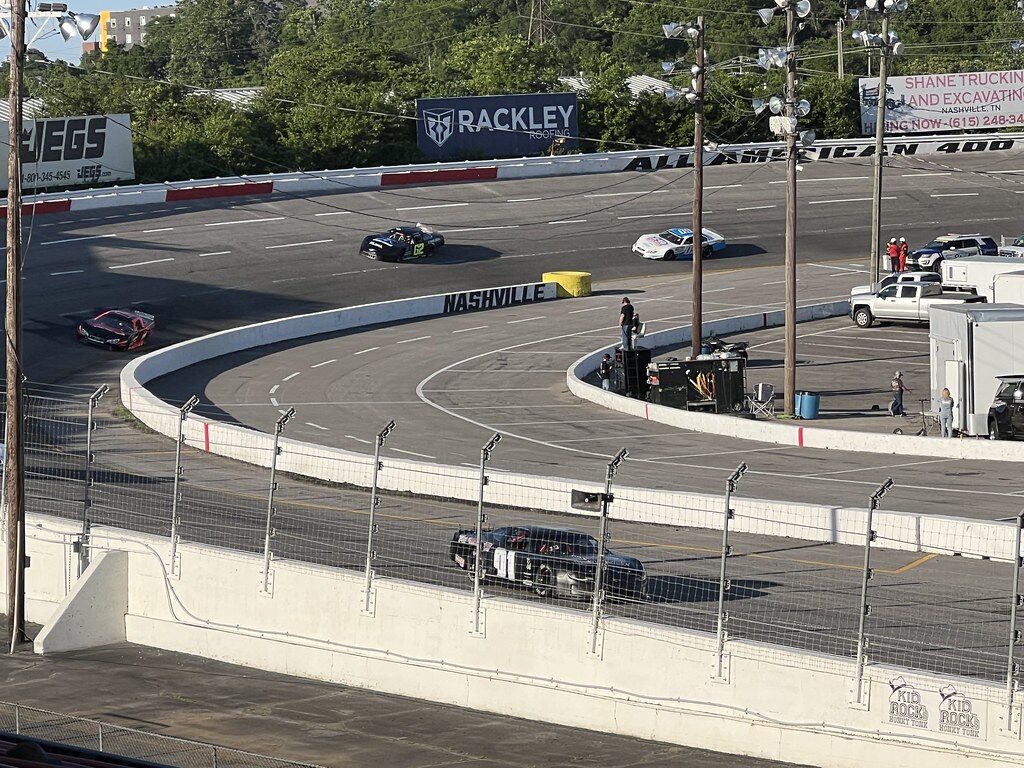 A Pro Late Model race car navigates a turn during weekly short-track racing action at Nashville Fairgrounds Speedway.