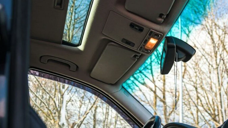 Open panoramic sunroof glass panel inside a vehicle cabin