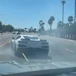 Tempe police video still of a white C8 Corvette being stopped with a Grappler net on a city street