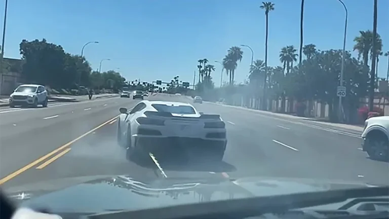 Tempe police video still of a white C8 Corvette being stopped with a Grappler net on a city street