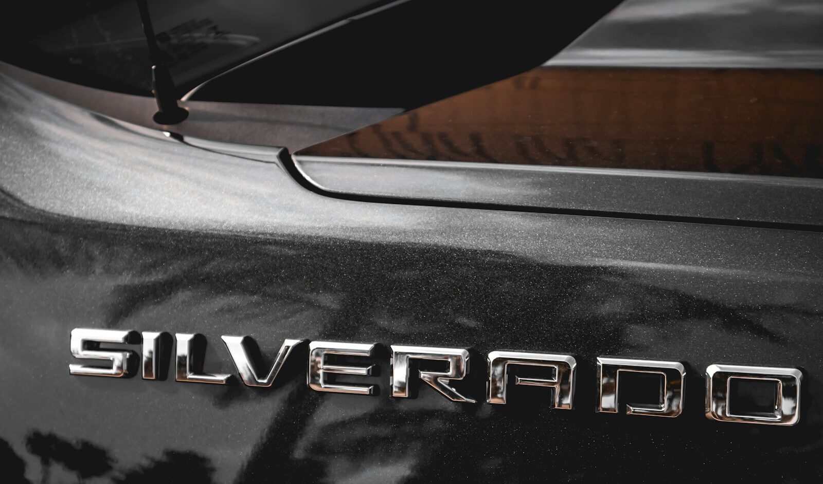 Close-up of a Chevrolet Silverado tailgate badge and rear window