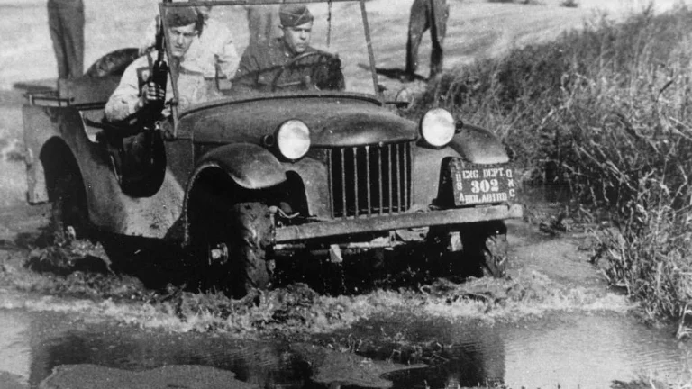 Bantam pilot jeep prototype carrying three soldiers through mud during Army testing at Camp Holabird in 1940