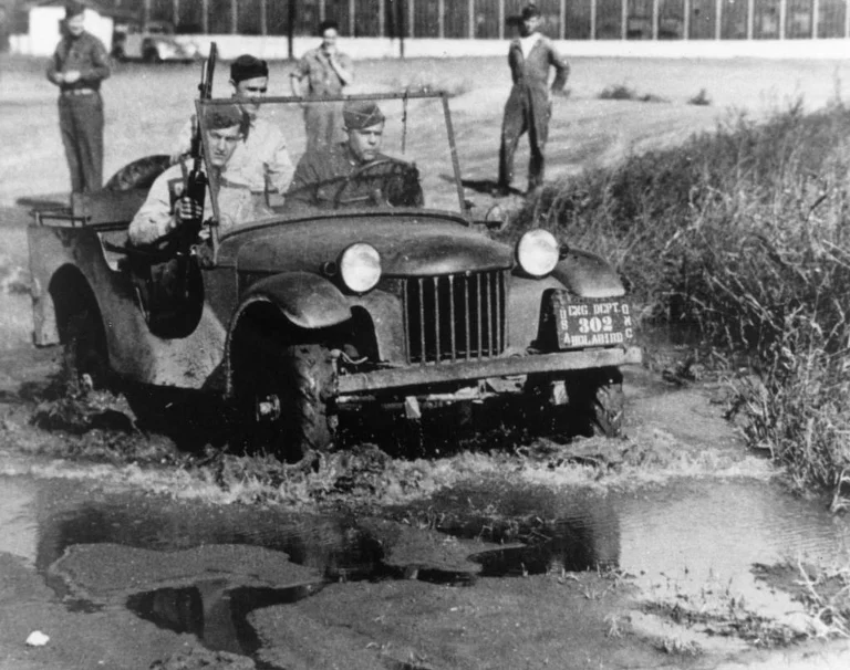 Bantam pilot jeep prototype carrying three soldiers through mud during Army testing at Camp Holabird in 1940