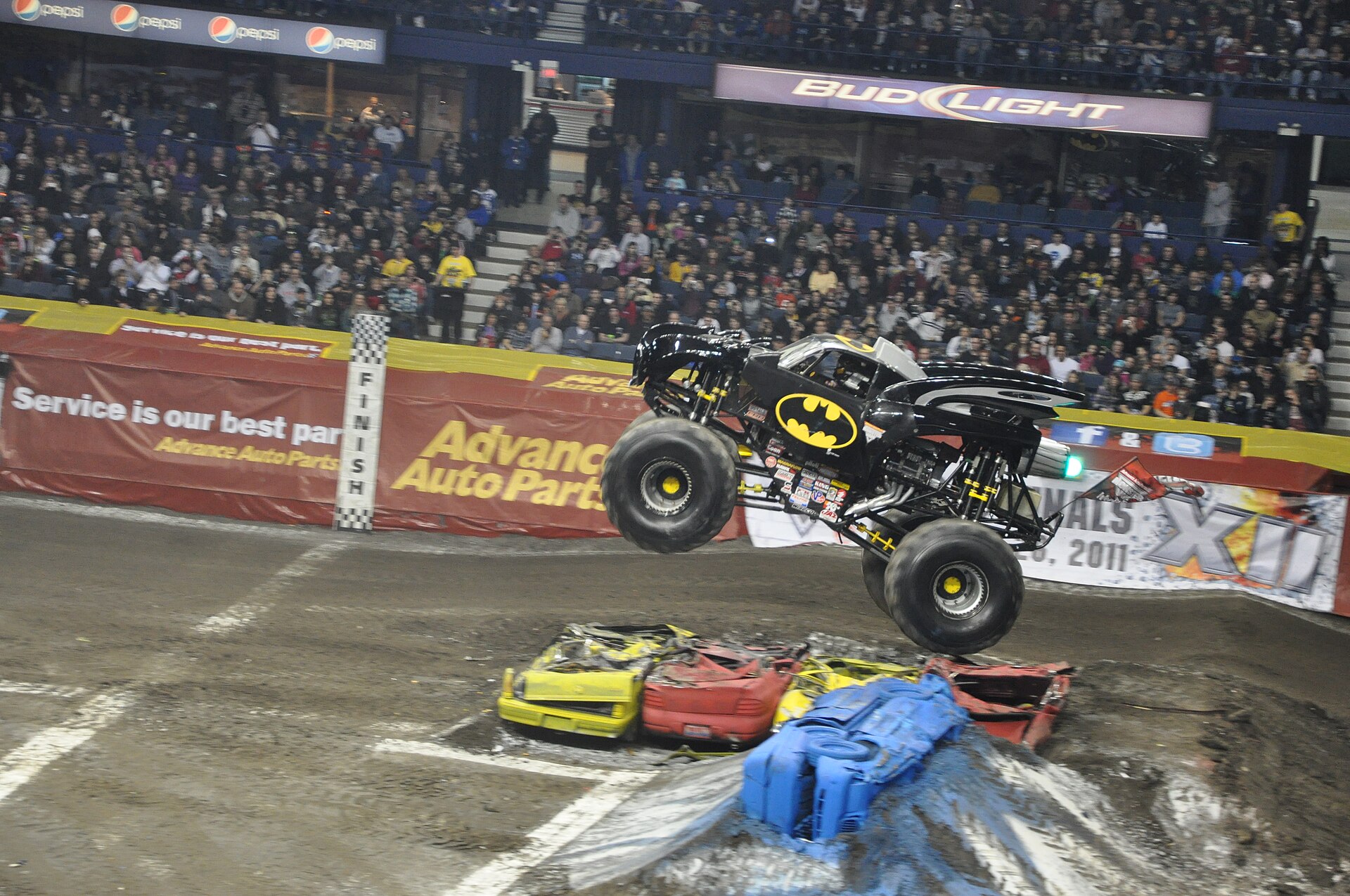 The Batman monster truck airborne over crushed cars at Monster Jam, Allstate Arena, 2011