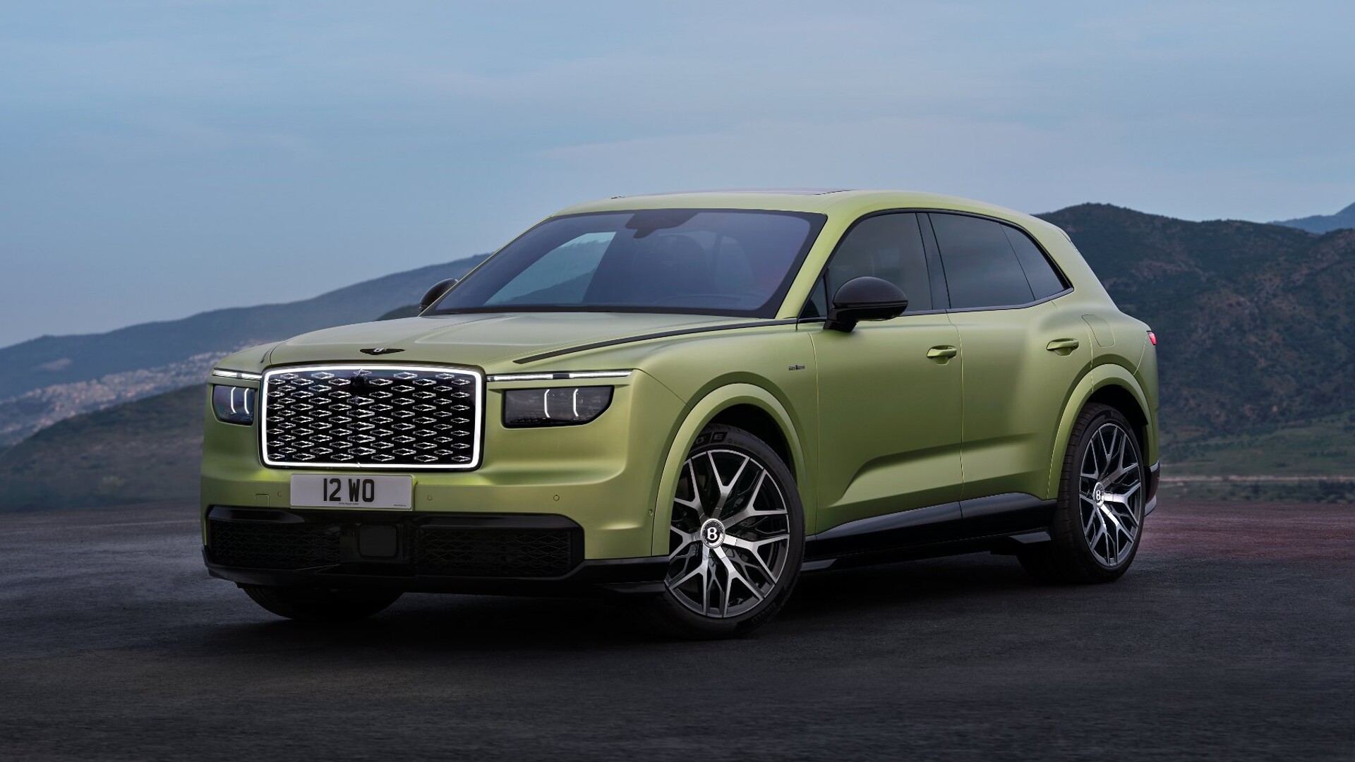 Green Bentley Torcal electric SUV front three-quarter view showing its diamond-pattern grille