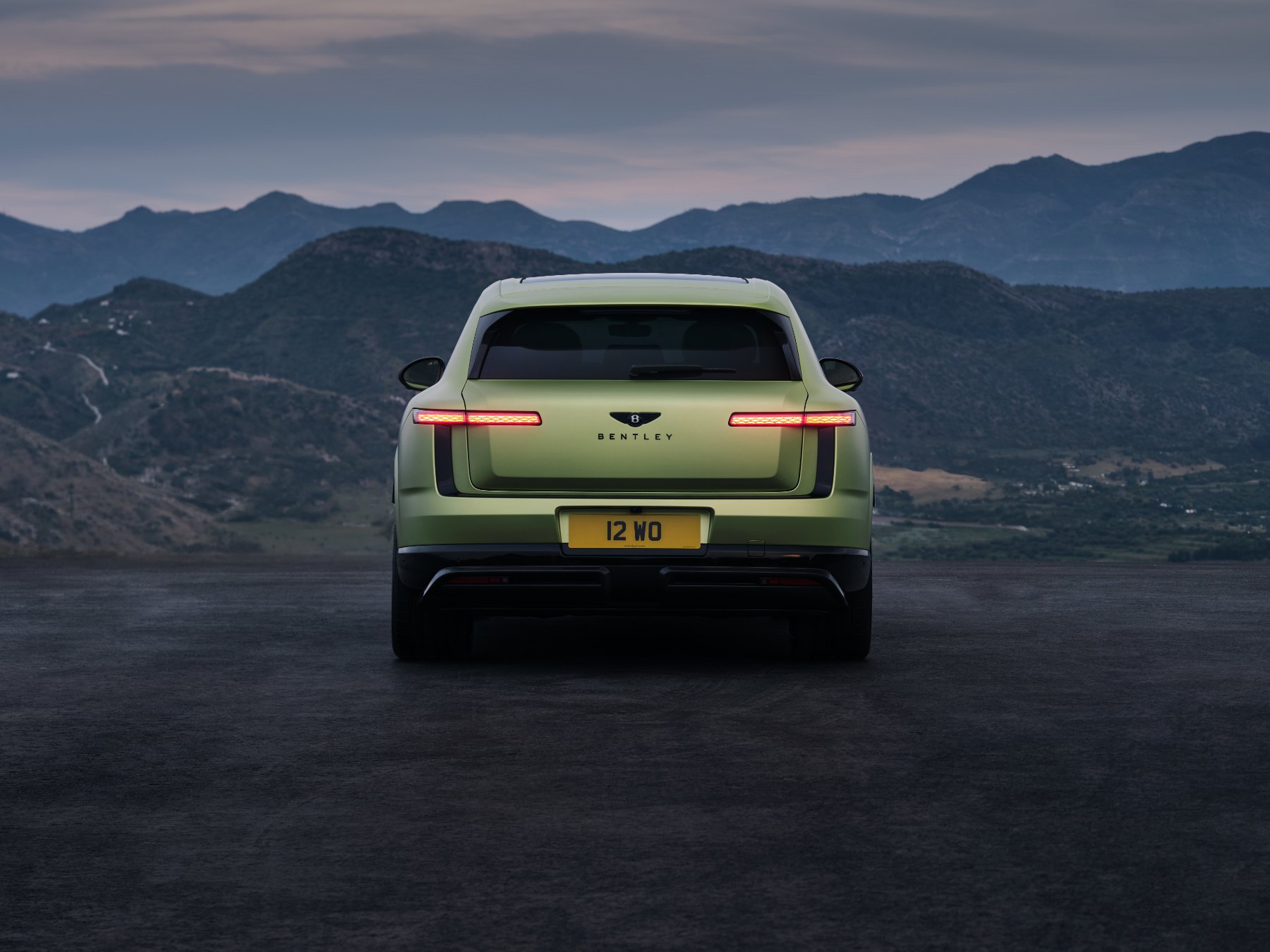 Rear view of a green Bentley Torcal with thin horizontal tail lamps and Bentley lettering