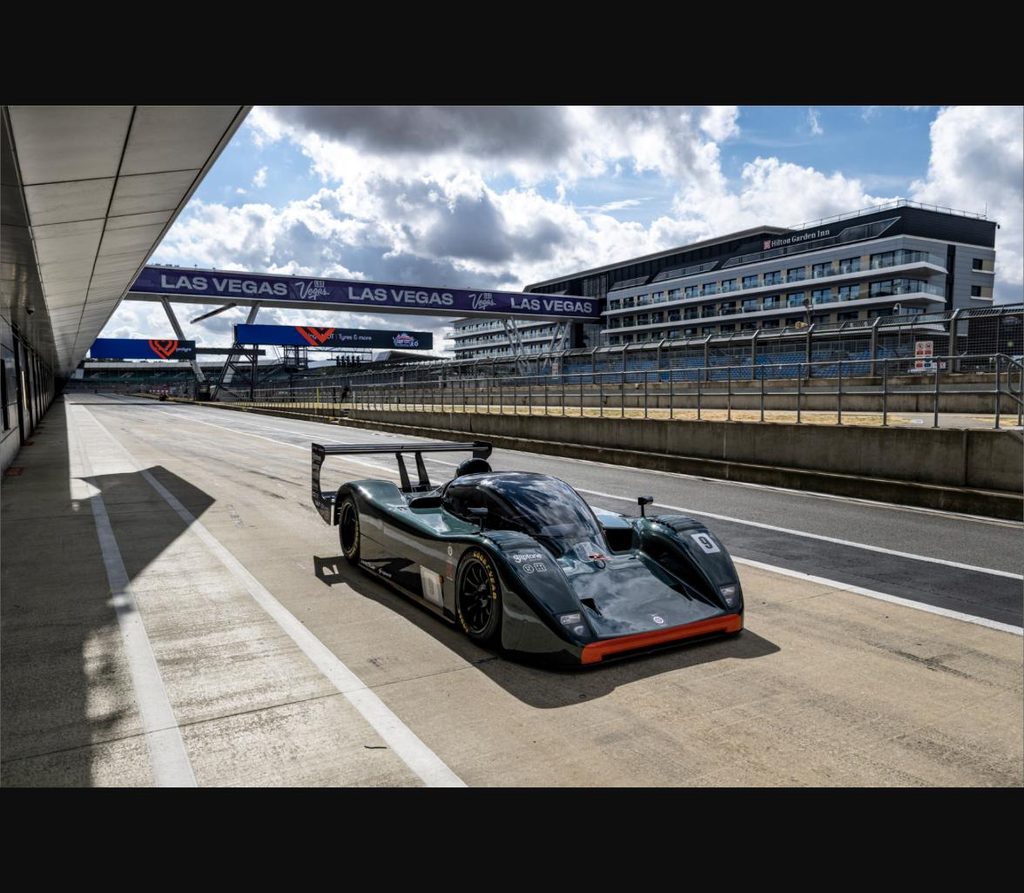 The restored BRM P351 in the Silverstone pit lane with the Las Vegas Grand Prix signage overhead