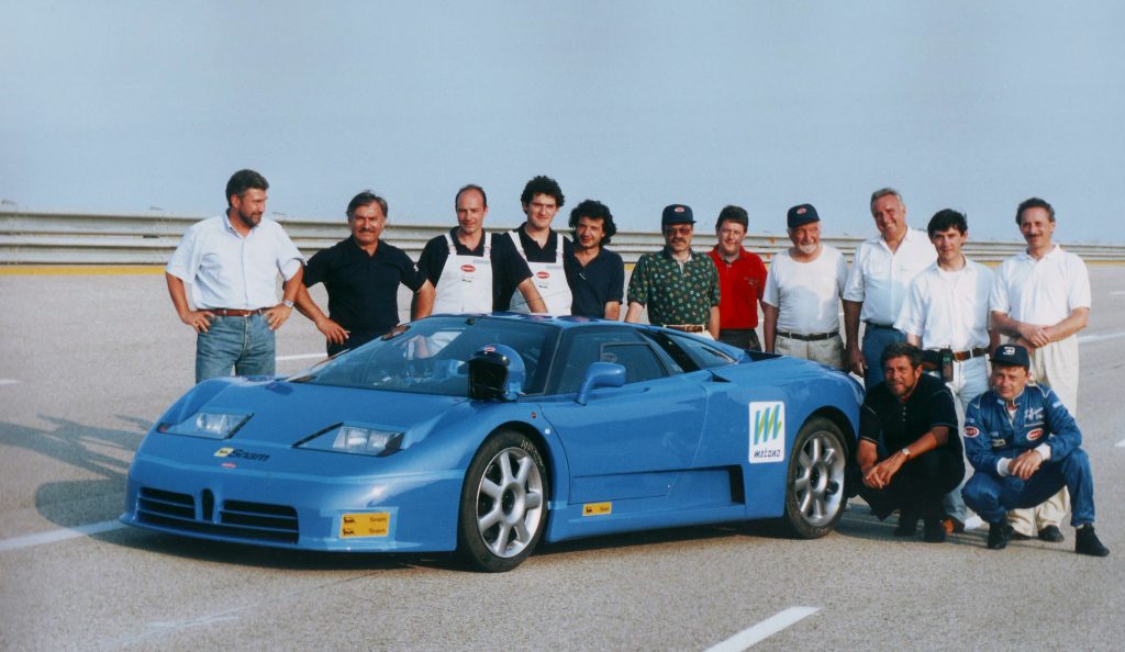 Blue Bugatti EB110 record car surrounded by the Campogalliano engineering team on the Nardo test track in July 1994