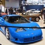 Blue Bugatti EB110 Super Sport displayed front three-quarter, showing its wedge nose, horseshoe grille and scissor-door greenhouse