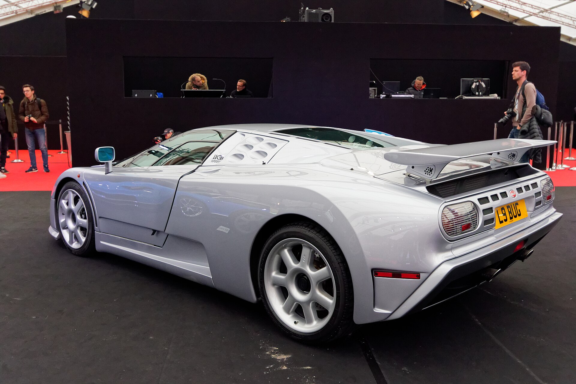 Silver 1993 Bugatti EB110 Super Sport prototype seen from the rear three-quarter, showing its fixed wing and louvred engine cover