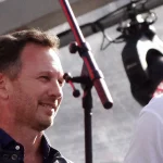 Christian Horner smiling on stage at the F1 Live event in London in July 2017